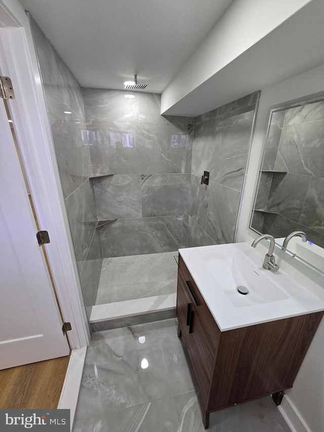 1055 E Cheltenham Ave, Philadelphia, PA 19124 - bathroom with tile walls, vanity, marble finish floor, and tiled shower