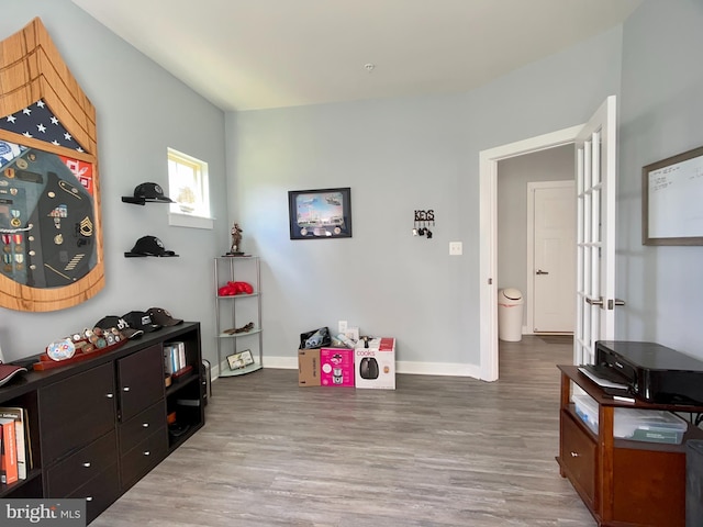 interior space featuring wood finished floors and baseboards