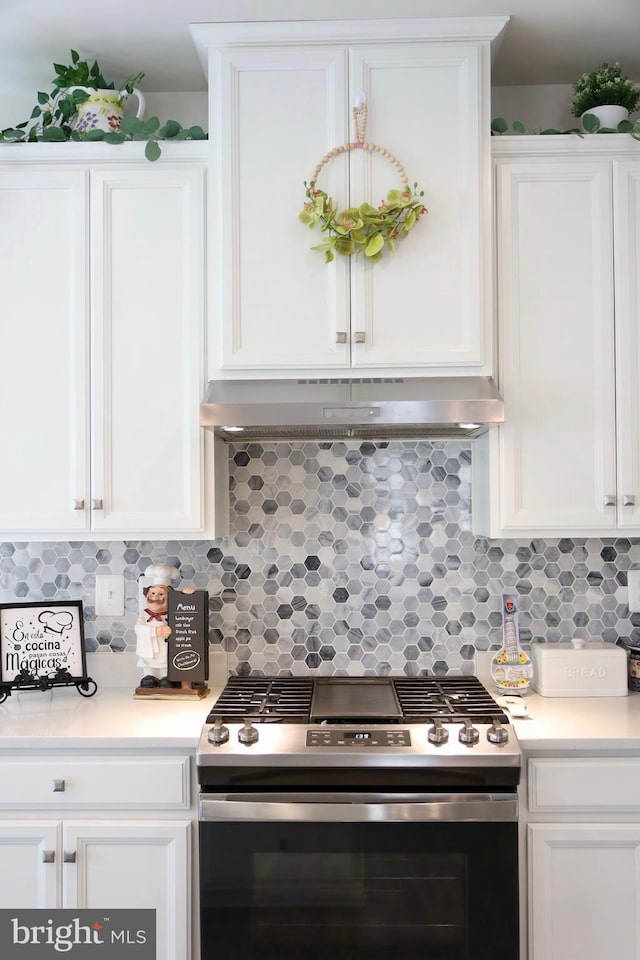 kitchen featuring stainless steel gas range oven and white cabinetry
