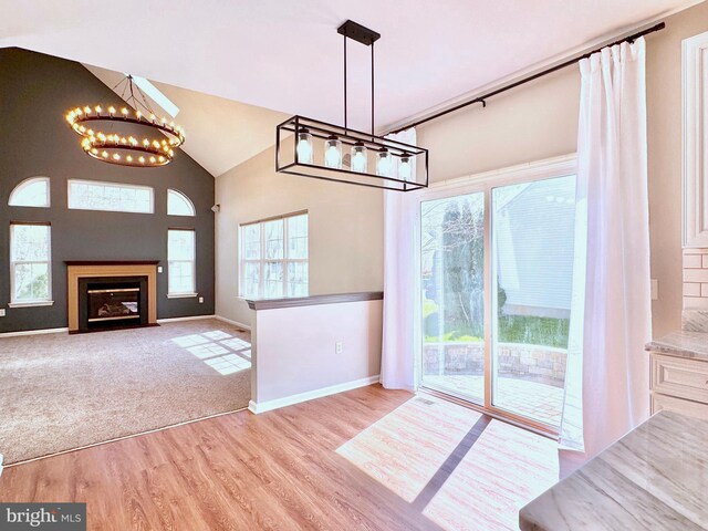 1 Donegal, Newark, DE 19702 - unfurnished dining area with an inviting chandelier, wood finished floors, plenty of natural light, and high vaulted ceiling