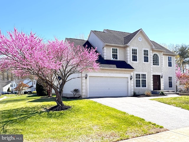 1 Donegal, Newark, DE 19702 - view of front facade with an attached garage, driveway, a front yard, and stucco siding