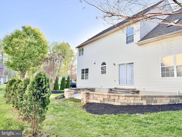 1 Donegal, Newark, DE 19702 - back of house with entry steps, a yard, and roof with shingles