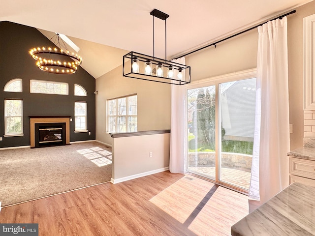 1 Donegal, Newark, DE 19702 - unfurnished dining area featuring vaulted ceiling, an inviting chandelier, wood finished floors, and plenty of natural light