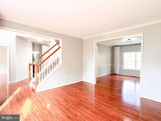 1 Donegal, Newark, DE 19702 - unfurnished room with baseboards, wood finished floors, stairs, and ornamental molding