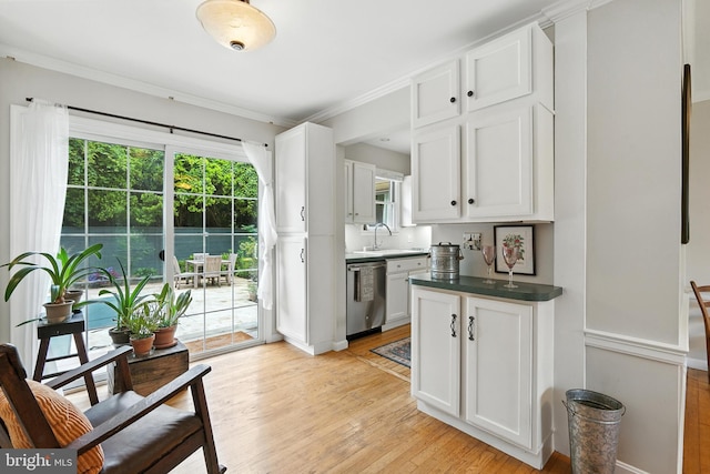 206 Barroll Dr, Chestertown, MD 21620 - kitchen with stainless steel dishwasher, white cabinets, light wood finished floors, ornamental molding, and dark countertops