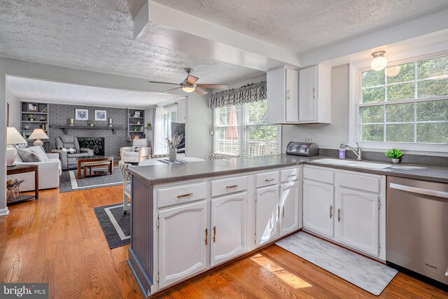 12910 Mayflower Ln, Bowie, MD 20720 - kitchen with light wood-type flooring, a textured ceiling, a peninsula, and dishwasher