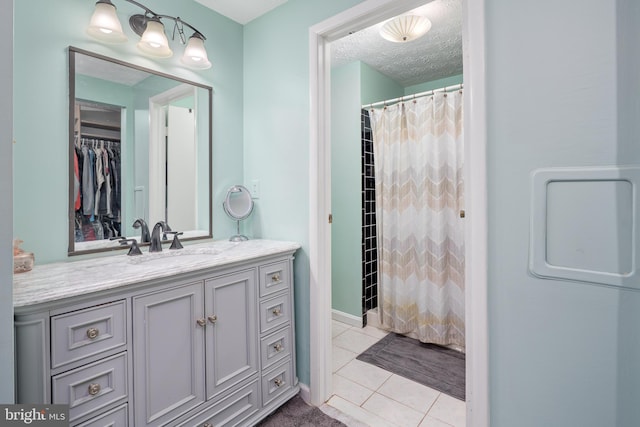 12910 Mayflower Ln, Bowie, MD 20720 - bathroom with tile patterned floors, a shower with curtain, a textured ceiling, and vanity