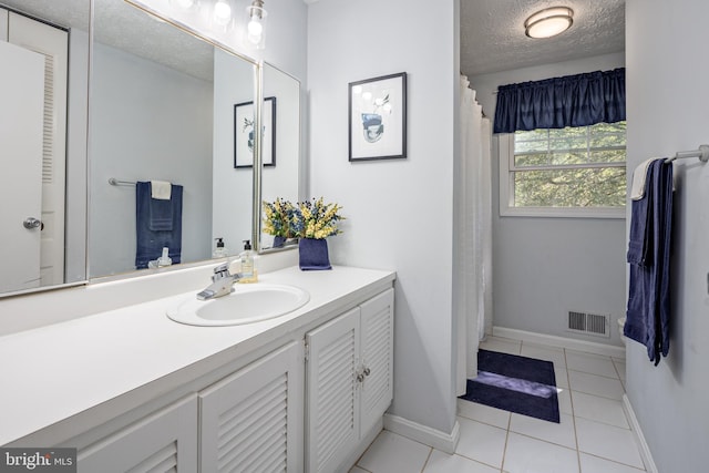 12910 Mayflower Ln, Bowie, MD 20720 - bathroom with a textured ceiling, visible vents, baseboards, tile patterned floors, and vanity