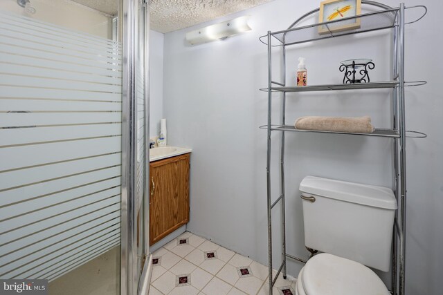 12910 Mayflower Ln, Bowie, MD 20720 - bathroom with tile patterned floors, a shower stall, toilet, vanity, and a textured ceiling