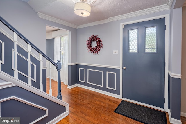 12910 Mayflower Ln, Bowie, MD 20720 - foyer with a textured ceiling, stairway, baseboards, ornamental molding, and wood finished floors