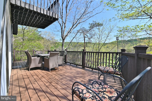 wooden terrace featuring outdoor dining space