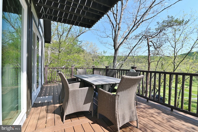 wooden deck featuring outdoor dining space