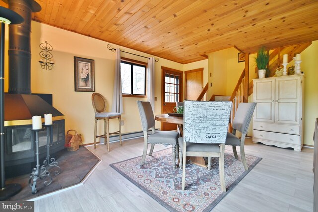 dining space with wooden ceiling, light wood-style flooring, and a baseboard radiator