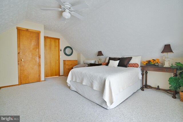 carpeted bedroom with ceiling fan, baseboards, and lofted ceiling