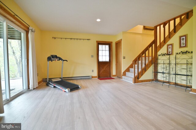 workout room with recessed lighting, baseboards, wood finished floors, and a baseboard radiator
