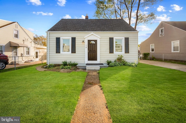 18 Crafton Rd, Baltimore, MD 21221 - view of front facade featuring a chimney, a shingled roof, fence, and a front yard