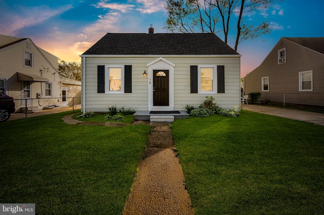 18 Crafton Rd, Baltimore, MD 21221 - view of front of property with a yard, fence, a chimney, and roof with shingles