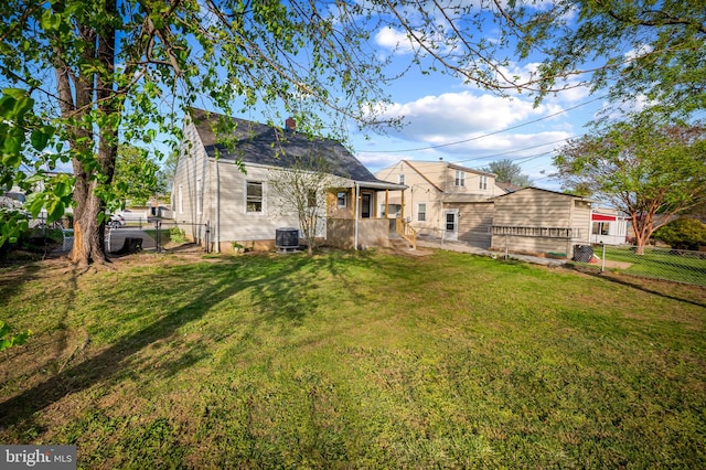 18 Crafton Rd, Baltimore, MD 21221 - rear view of house featuring a fenced backyard, a yard, and central AC