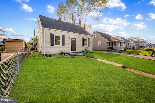 18 Crafton Rd, Baltimore, MD 21221 - cape cod house featuring a chimney, a shingled roof, fence, and a front yard