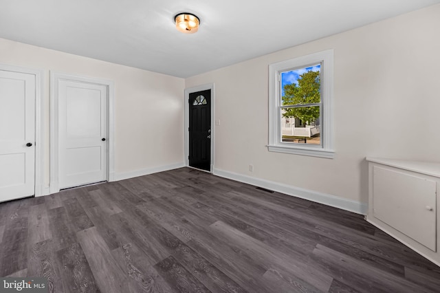 18 Crafton Rd, Baltimore, MD 21221 - unfurnished bedroom with baseboards, visible vents, and dark wood-type flooring