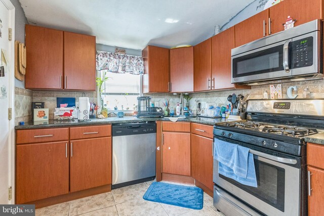 3526 Welsh Rd, Philadelphia, PA 19136 - kitchen with brown cabinetry, backsplash, stainless steel appliances, and light tile patterned floors
