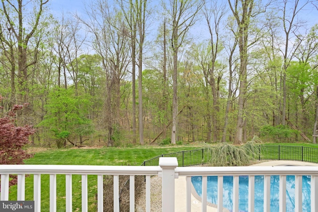 view of swimming pool featuring a fenced in pool, fence, and a yard