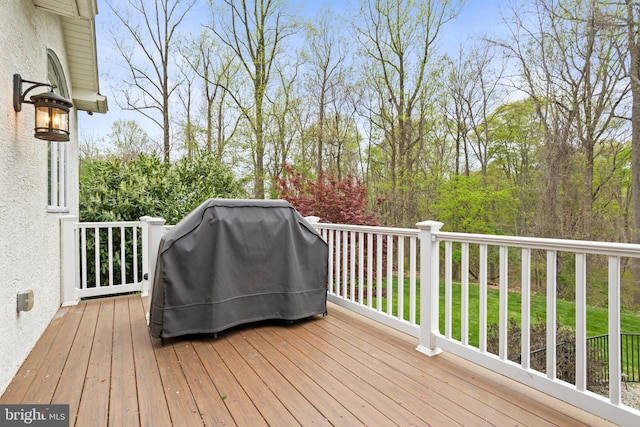 wooden deck featuring area for grilling