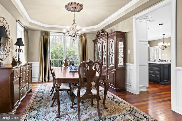 dining space with an inviting chandelier, dark wood-style flooring, and a healthy amount of sunlight