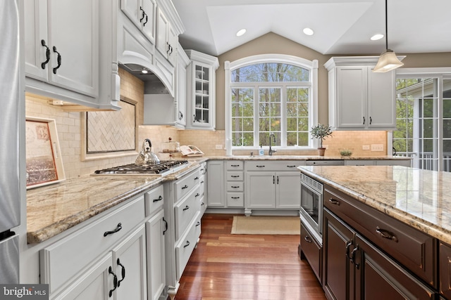 kitchen with a sink, appliances with stainless steel finishes, white cabinets, and a wealth of natural light