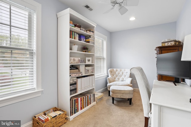 office area with visible vents, carpet flooring, baseboards, and ceiling fan