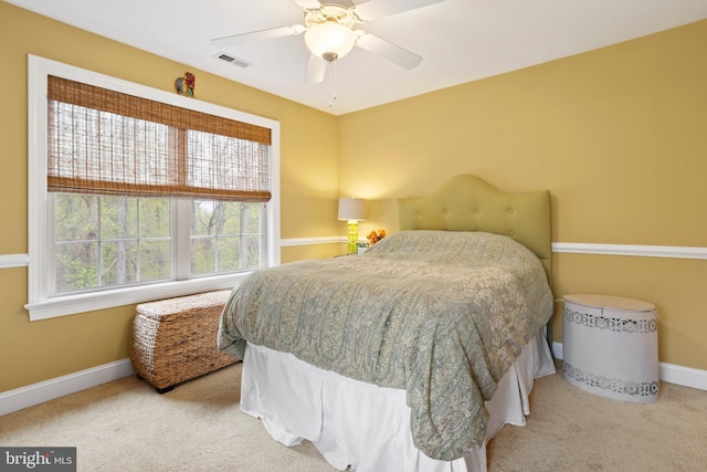 bedroom featuring carpet flooring, a ceiling fan, baseboards, and visible vents