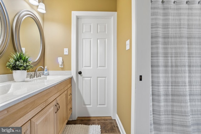 bathroom with vanity, baseboards, a shower with shower curtain, and tile patterned floors