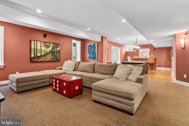 living room with recessed lighting, baseboards, and wood finished floors