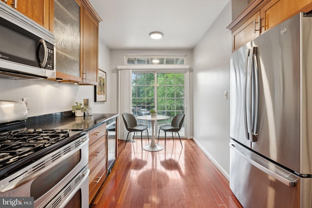 1617 Potomac Greens Dr Unit A, Alexandria, VA 22314 - kitchen with appliances with stainless steel finishes, wine cooler, hardwood / wood-style floors, baseboards, and brown cabinetry