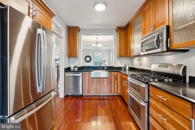 1617 Potomac Greens Dr Unit A, Alexandria, VA 22314 - kitchen with appliances with stainless steel finishes, brown cabinetry, dark wood finished floors, and a sink