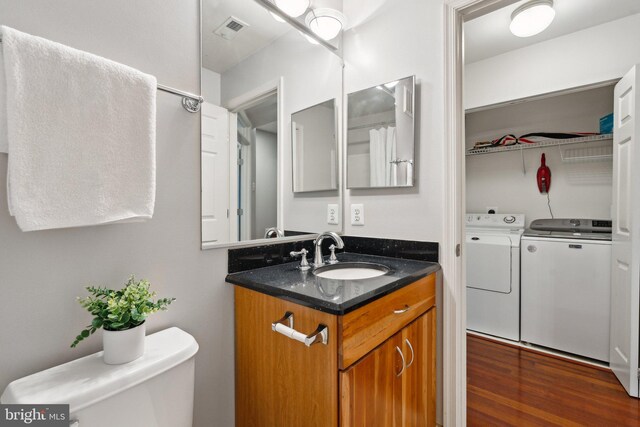 1617 Potomac Greens Dr Unit A, Alexandria, VA 22314 - bathroom with independent washer and dryer, vanity, toilet, and wood finished floors