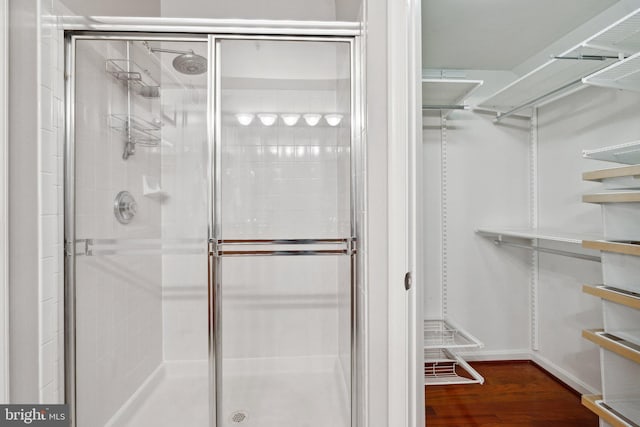 1617 Potomac Greens Dr Unit A, Alexandria, VA 22314 - bathroom featuring a shower stall, wood finished floors, and baseboards