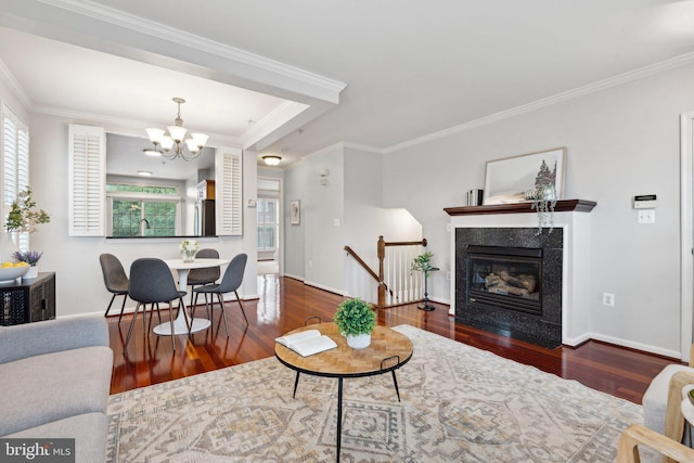 1617 Potomac Greens Dr Unit A, Alexandria, VA 22314 - living room with wood finished floors, a chandelier, crown molding, baseboards, and a fireplace