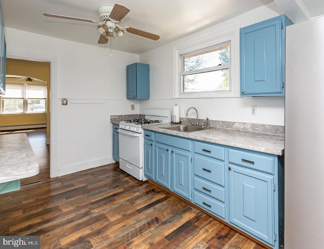kitchen with a sink, gas range gas stove, and blue cabinetry