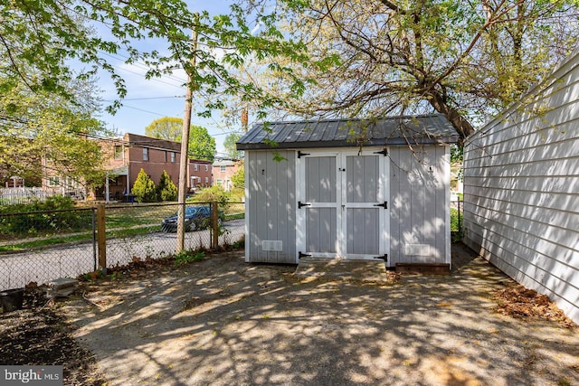 view of shed featuring fence