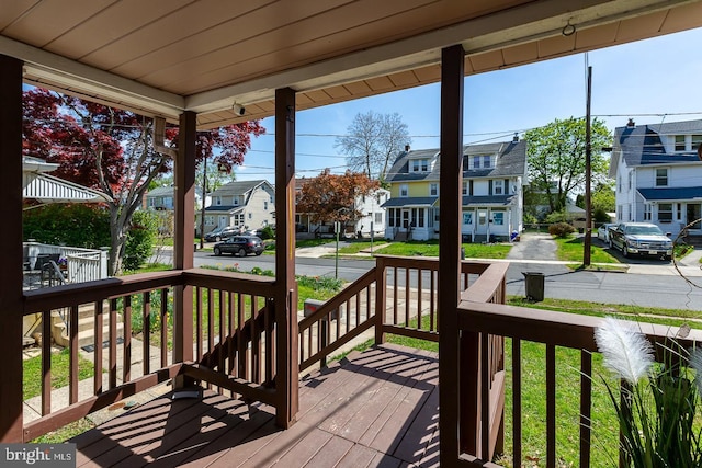 wooden terrace with a porch and a residential view