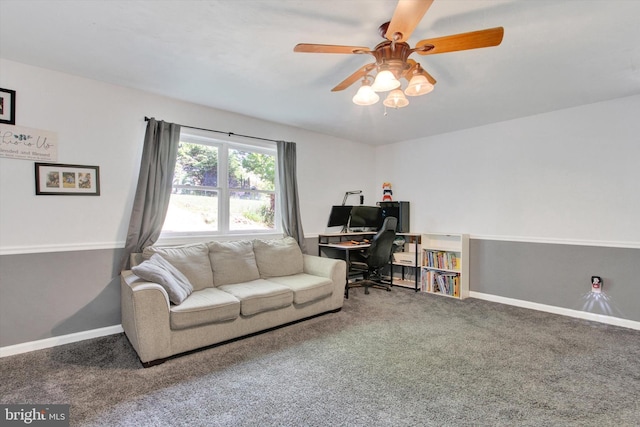 living area featuring baseboards, carpet, and a ceiling fan