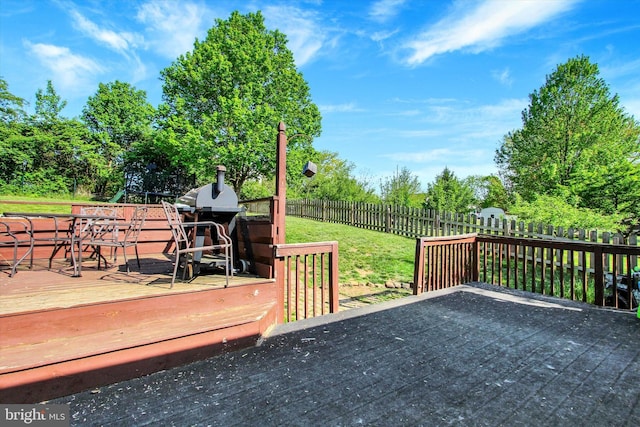 deck with a yard and fence