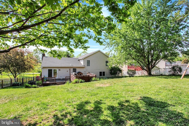view of yard with a fenced backyard and a wooden deck
