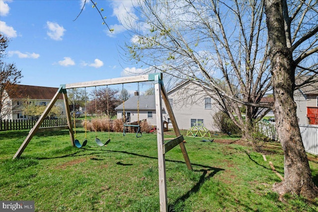 view of play area featuring a lawn and fence