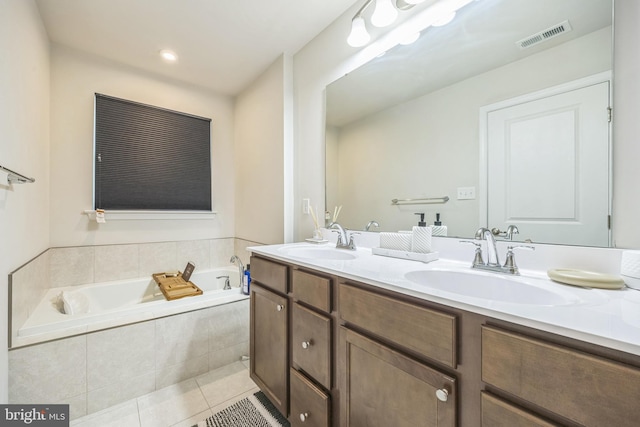 full bathroom featuring visible vents, a sink, tile patterned flooring, and double vanity