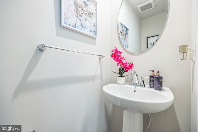 bathroom featuring visible vents and a sink