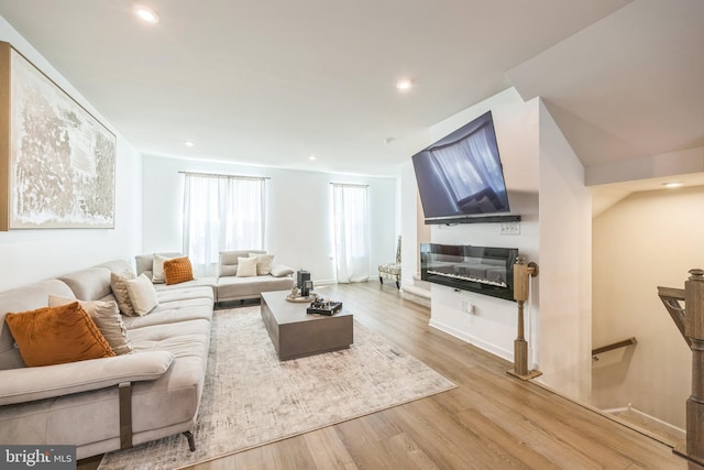 living room with recessed lighting and wood finished floors