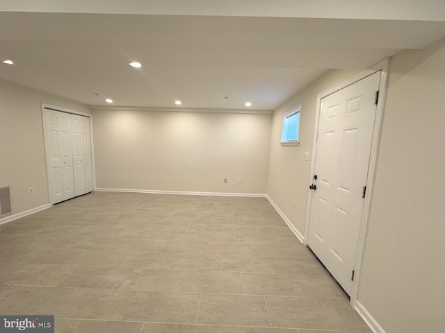 basement featuring baseboards and recessed lighting