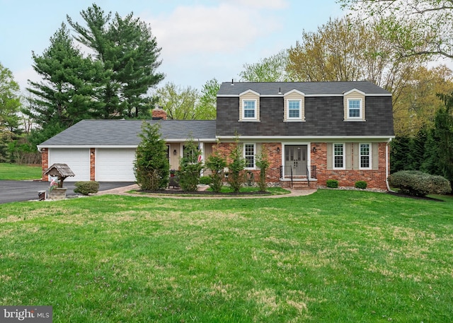 view of front of house featuring a garage, driveway, a shingled roof, a front yard, and brick siding